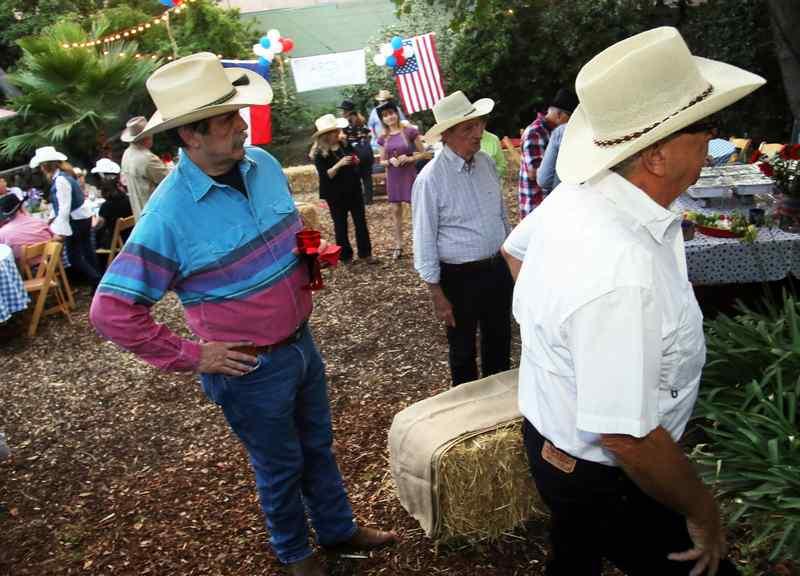 Guests wear cowboy hats at the Texas barbecue. (Photo by James Carbone)